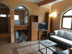 a living room with a couch and a tv at Apartment Aki in Kotor