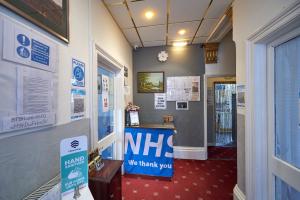 a hallway with a mhs sign on the wall at The Wilton International in Blackpool