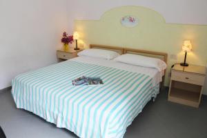 Postel nebo postele na pokoji v ubytování Hotel Villa Cecilia