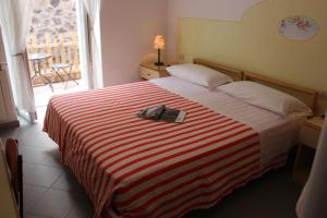 Postel nebo postele na pokoji v ubytování Hotel Villa Cecilia