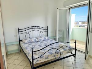 a bedroom with a bed and a balcony at Oltre l’orizzonte in Fermo