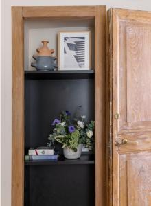 a shelf with two vases with flowers on it at MyNavona in Rome