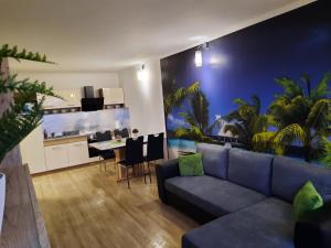 a living room with a couch and a dining room at Vandus apartman in Siófok