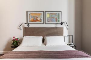 a bedroom with a bed with two white pillows at MyNavona in Rome