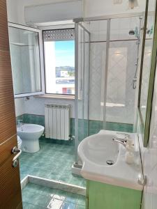 a bathroom with a sink and a shower and a toilet at Oltre l’orizzonte in Fermo
