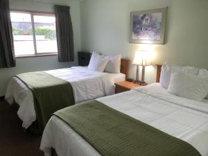 a hotel room with two beds and a window at Travelodge by Wyndham Seattle North of Downtown in Seattle