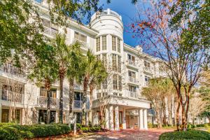 a large white building with trees in front of it at The Grand 2311 in Destin