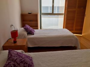 a hotel room with two beds and a window at Casa de pueblo amplia in Sa Pobla +7 photos