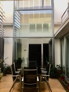 a dining room with glass walls and a table and chairs at Casa de pueblo amplia in Sa Pobla