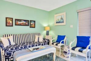 a living room with a couch and two chairs at Mariners Cove 302 in New Smyrna Beach