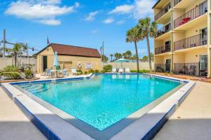 a swimming pool in front of a apartment building at Mariners Cove 302 in New Smyrna Beach