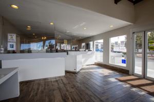 a lobby with a white counter and wooden floors at Hotel Aspen Flagstaff/ Grand Canyon InnSuites in Flagstaff +70 photos