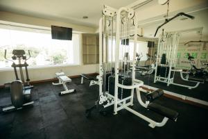 a gym with several tread machines and a window at Hotel Araiza Hermosillo in Hermosillo