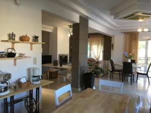 a living room with a kitchen and a dining room at Seascape Village in Kalithies