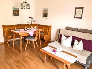 a living room with a couch and a table at Ferienwohnungen Meyerlhof in Aschau im Chiemgau