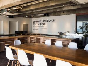 a conference room with a table and white chairs at SHIRAHAMA KEY TERRACE SEAMORE RESIDENCE - Vacation STAY 35167v in Kanayama