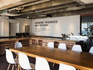 a conference room with a table and white chairs at SHIRAHAMA KEY TERRACE SEAMORE RESIDENCE - Vacation STAY 35168v in Kanayama