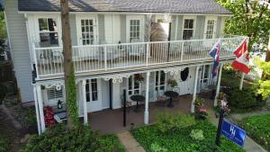 una casa con terrazza bianca e balcone di Harrogate House Inn a Niagara on the Lake