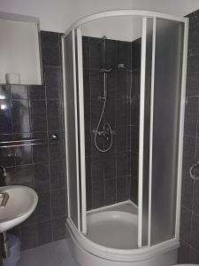 a bathroom with a shower and a toilet and a sink at Apartments Martin in Primošten