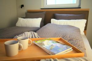 Ein Bett oder Betten in einem Zimmer der Unterkunft Überlinger See-Apartments Penthouse Über-See