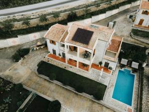 an aerial view of a house with a swimming pool at Villa Milena in Syvota