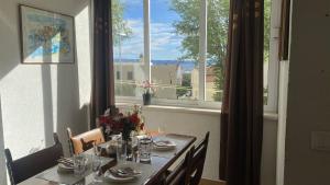 a dining room table with a view of a window at Makarska Apartment Marijo in Makarska