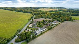 an aerial view of a large house in a field at Maple, Country Chalet in Pegsdon in Hexton