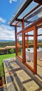 a glass house with a bath tub in a yard at Villa Monica HR in Villa de Leyva