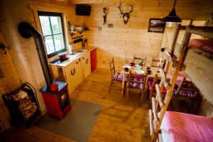 a kitchen and dining room with a table and a stove at Horse Lake Ranch in Neuendorf