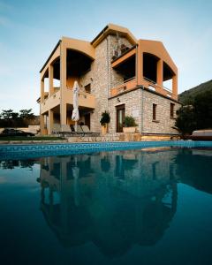 a house with a swimming pool in front of it at Villa Milena in Syvota