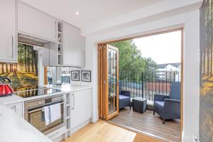 a kitchen with a view of a balcony at Lovely 1-Bed Apartment in London in London