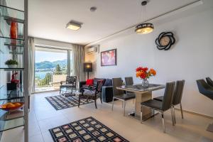 a living room with a table and chairs and a couch at Apartment Sweet Memories in Sveti Stefan