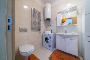 a bathroom with a toilet sink and a washing machine at Apartment Sweet Memories in Sveti Stefan