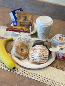 a plate of pastries and a banana and a cup of coffee at Yellowstone Lodge in West Yellowstone