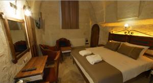 A bed or beds in a room at Zuwinasa House Hotel