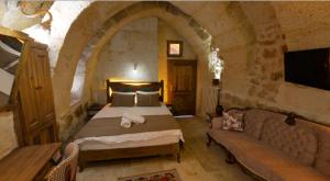A bed or beds in a room at Zuwinasa House Hotel