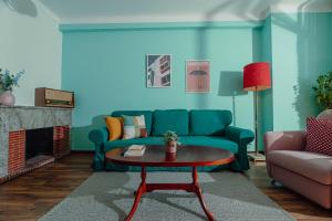 een woonkamer met een groene bank en een tafel bij Appartements - Centre Ville in Rabat