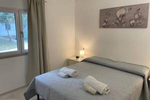 A bed or beds in a room at Giorgia&Greta- relax casa vacanze