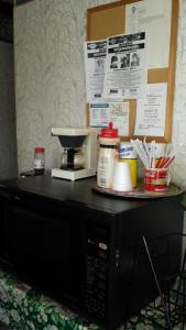 a microwave with a coffee maker on top of it at Executive Lodge in Alcoa
