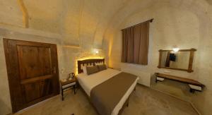 A bed or beds in a room at Zuwinasa House Hotel