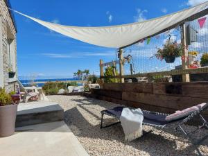 a patio with a hammock and a white canopy at Hillside Cottage in Letterkenny