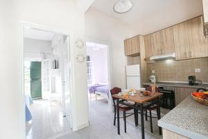 a kitchen and dining room with a table and chairs at Angela's house by the sea in Marathias