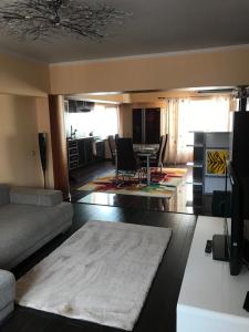 a living room with a couch and a table at Goa Central apartament in Drobeta-Turnu Severin
