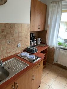 a kitchen with a sink and a stove top oven at Apartament 3 pokojowy Międzyzdoje 55m2 - 200 metrów od morza in Międzyzdroje