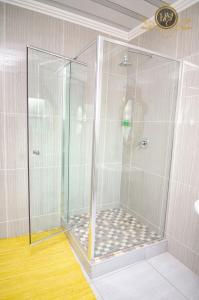 a shower with a glass enclosure in a bathroom at House of Sollys Guesthouse in Manamane