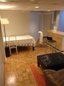 a living room with a bed and a desk at Apt Near Downtown in Montreal