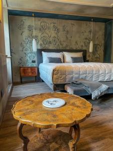 a bedroom with a bed and a table with a coffee table at DIMORA SCURONE in Cannobio