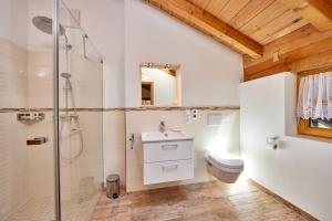a bathroom with a shower and a sink and a toilet at Appartements Gasthof Schleifmühle Unterammergau in Unterammergau +25 photos
