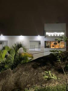 a white building with a sign on it at night at Barueri Premiêr Hotel in Barueri