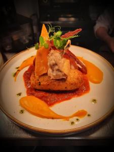 a plate of food with meat and sauce at The Dolphin Hotel in Mayo